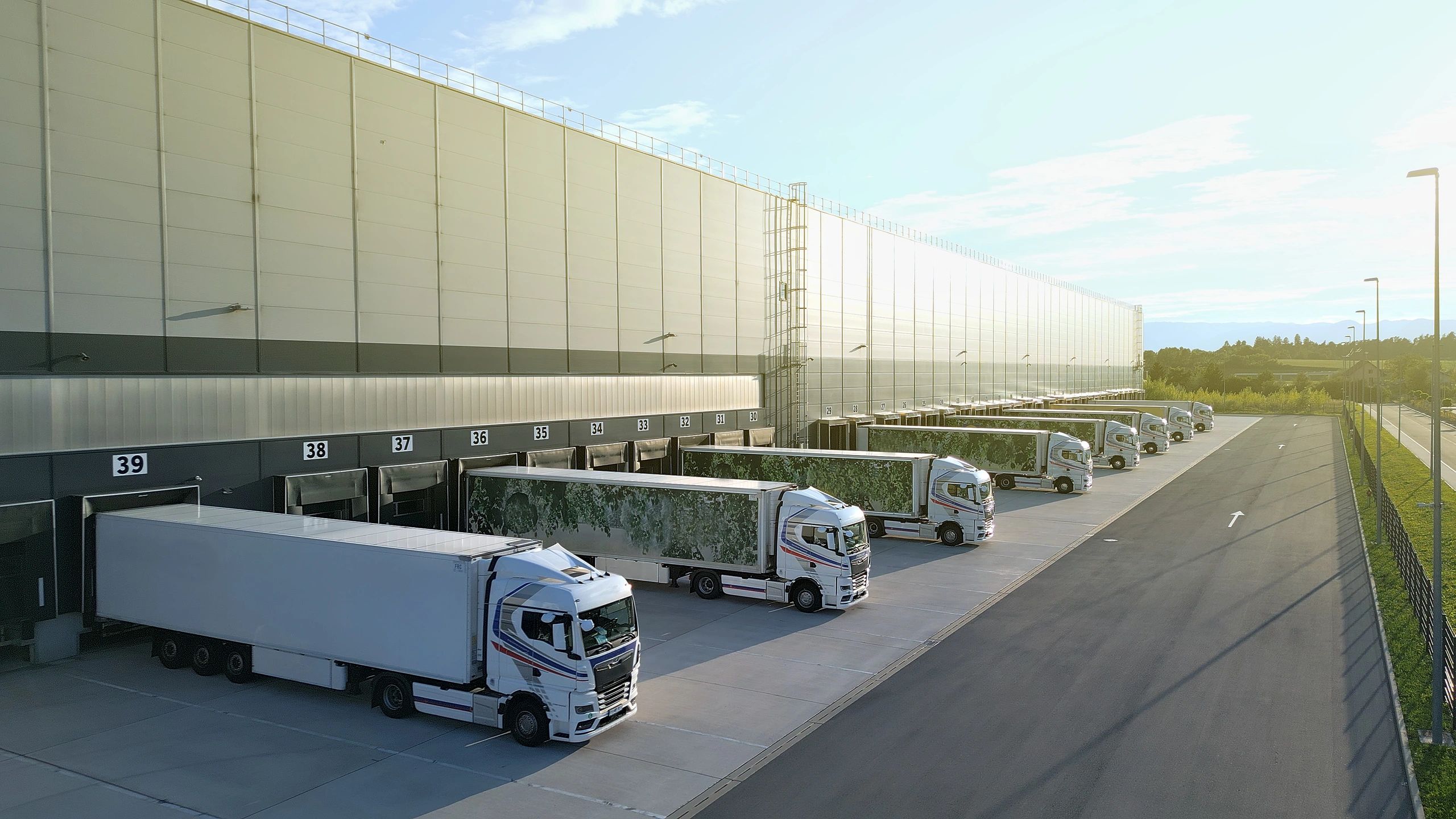 Commercial trucks at a modern distribution warehouse